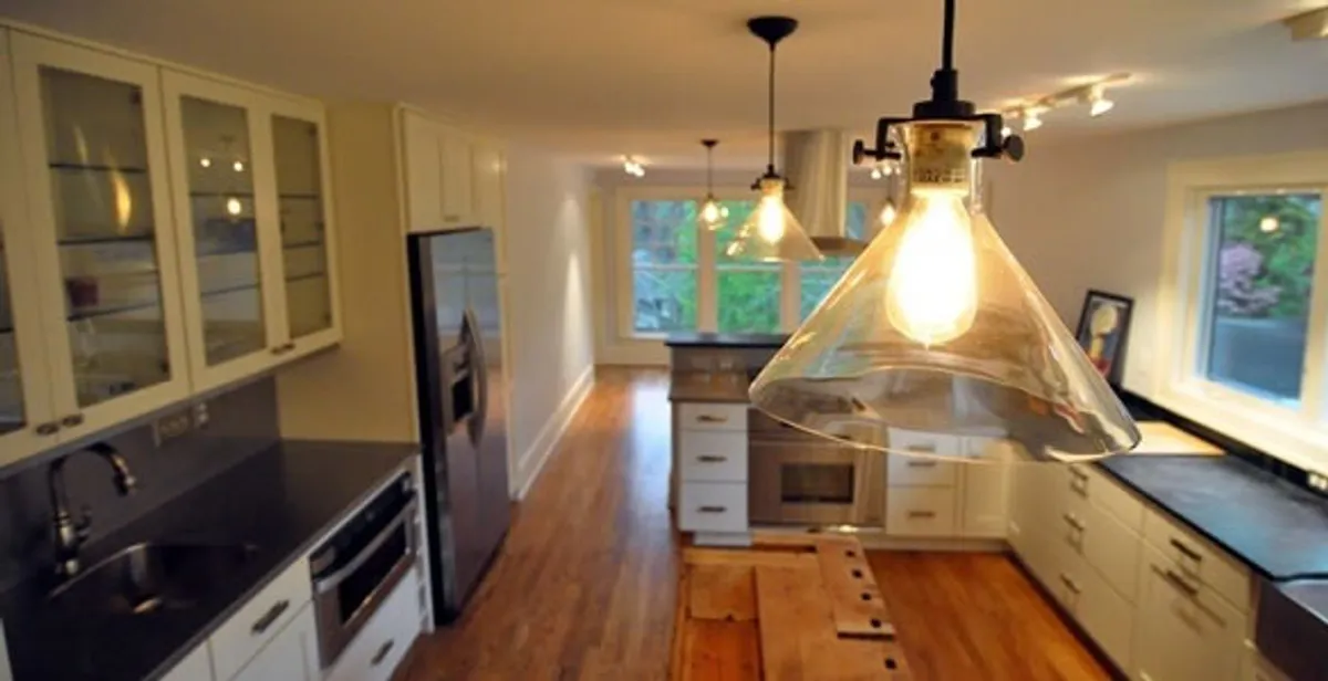 Residential electrician installing modern indoor light fixture in a home in Las Vegas, NV